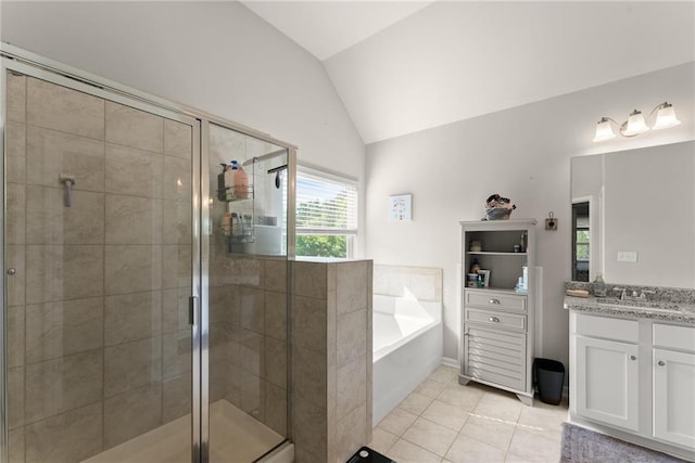 bathroom with lofted ceiling, vanity, a shower stall, tile patterned flooring, and a garden tub