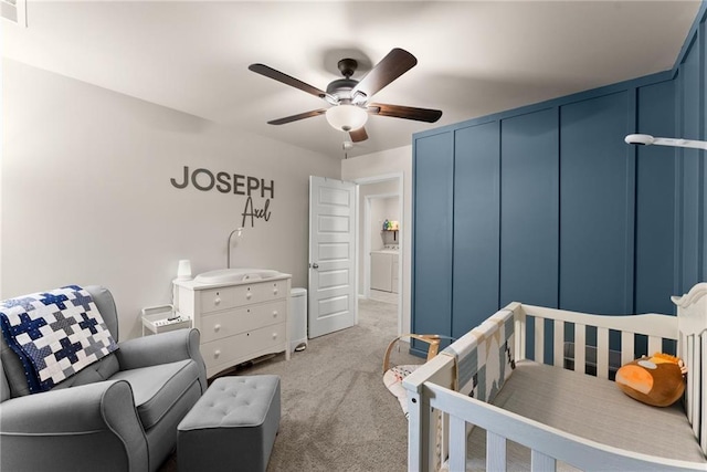 carpeted bedroom featuring washer / clothes dryer and a ceiling fan