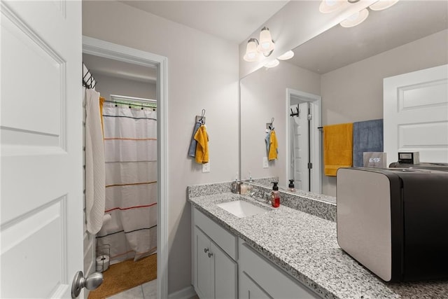 bathroom featuring vanity and a shower with shower curtain
