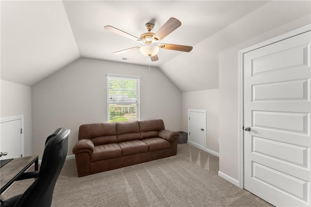office space featuring lofted ceiling, light colored carpet, ceiling fan, and baseboards