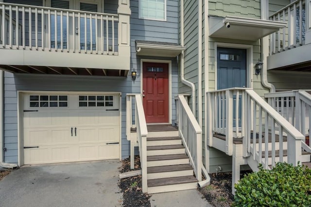 property entrance with an attached garage and concrete driveway