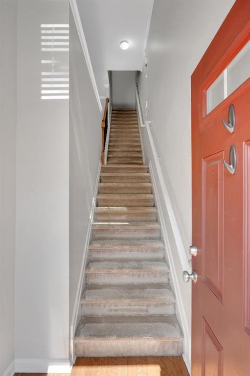 stairway featuring wood finished floors