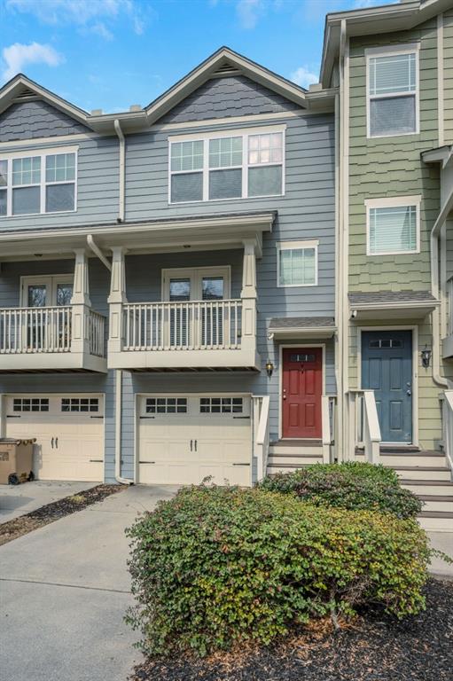 townhome / multi-family property featuring a garage and driveway