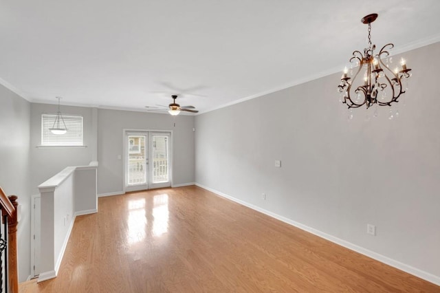 unfurnished living room featuring baseboards, ceiling fan, crown molding, french doors, and light wood-type flooring