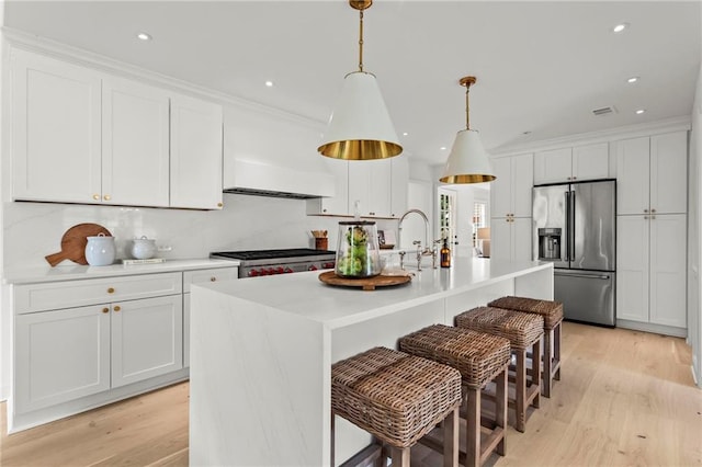 600 Delphinium Blvd NW, Acworth, GA 30102 - kitchen featuring stainless steel fridge, stove, white cabinets, light wood-style floors, and recessed lighting