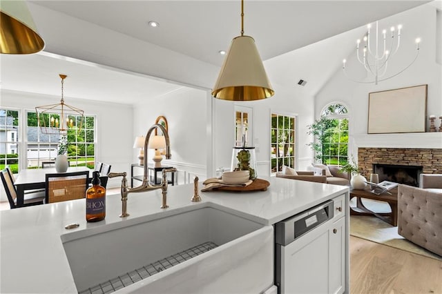 600 Delphinium Blvd NW, Acworth, GA 30102 - kitchen with a chandelier, dishwasher, a sink, pendant lighting, and light wood-style floors