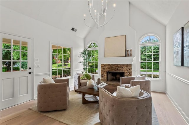 600 Delphinium Blvd NW, Acworth, GA 30102 - living room featuring a chandelier, wood finished floors, high vaulted ceiling, and a stone fireplace