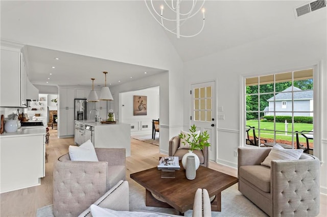600 Delphinium Blvd NW, Acworth, GA 30102 - living area with light wood-type flooring, high vaulted ceiling, a chandelier, and recessed lighting