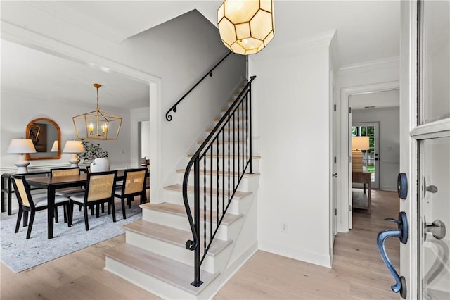 600 Delphinium Blvd NW, Acworth, GA 30102 - stairs with ornamental molding, wood finished floors, a chandelier, and baseboards