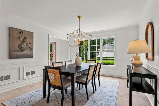 600 Delphinium Blvd NW, Acworth, GA 30102 - dining space featuring a chandelier, ornamental molding, light wood-type flooring, and a decorative wall
