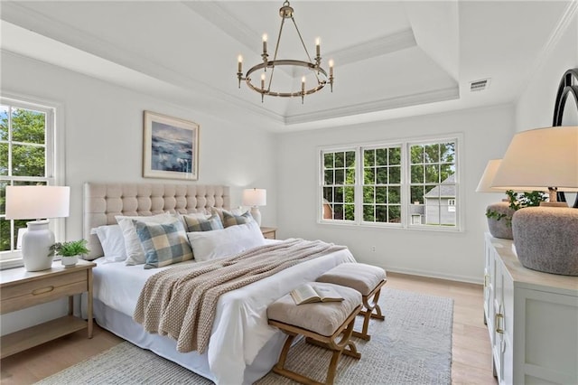 600 Delphinium Blvd NW, Acworth, GA 30102 - bedroom with a raised ceiling, ornamental molding, a chandelier, light wood-style floors, and baseboards