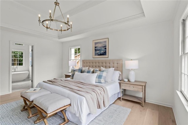 600 Delphinium Blvd NW, Acworth, GA 30102 - bedroom with a raised ceiling, light wood-style flooring, a chandelier, multiple windows, and ornamental molding