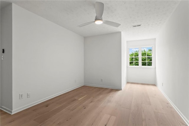 600 Delphinium Blvd NW, Acworth, GA 30102 - empty room with light wood-style floors, a ceiling fan, a textured ceiling, and baseboards