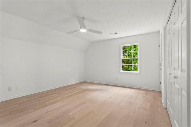 600 Delphinium Blvd NW, Acworth, GA 30102 - unfurnished bedroom with light wood finished floors, lofted ceiling, baseboards, a closet, and ceiling fan