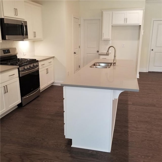 kitchen with white cabinetry, sink, an island with sink, and appliances with stainless steel finishes