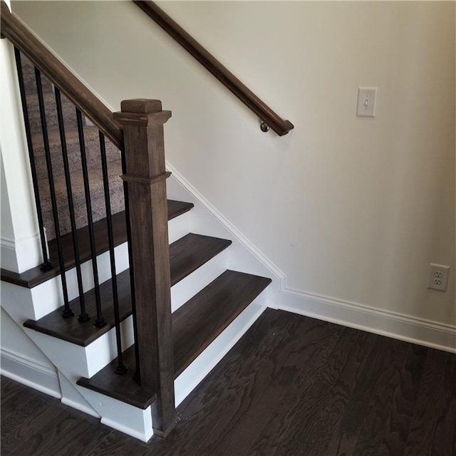 stairs featuring hardwood / wood-style flooring