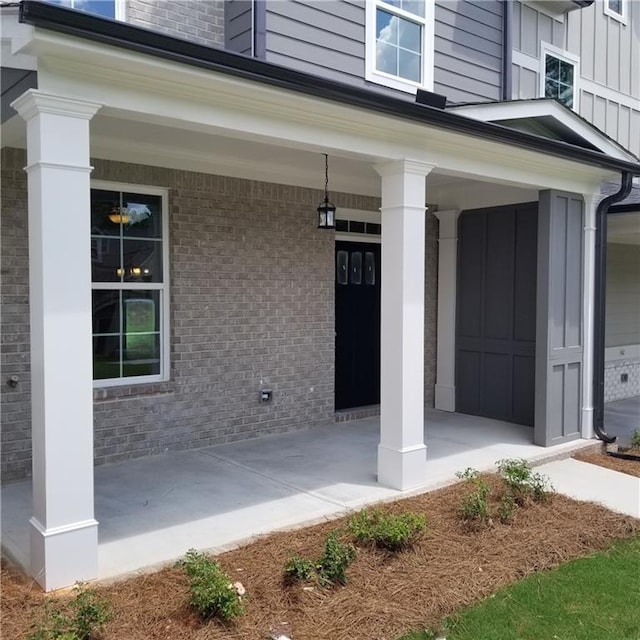 view of exterior entry featuring a porch