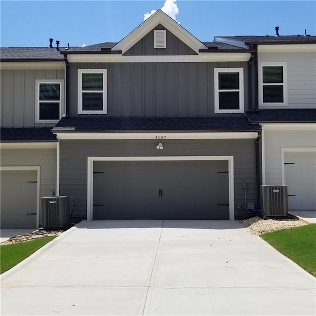 exterior space with a garage and central AC unit