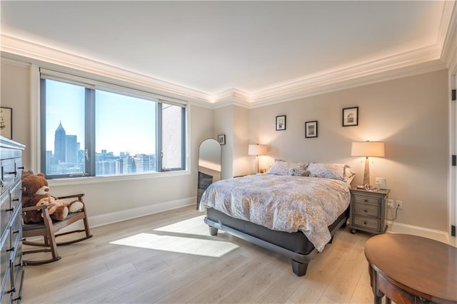 bedroom with a view of city, light wood-type flooring, baseboards, and crown molding