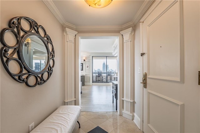 interior space featuring light tile patterned floors, ornamental molding, and ornate columns