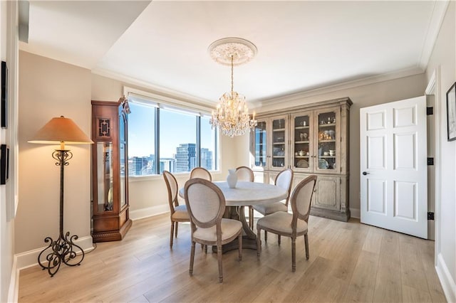 dining area with a chandelier, a view of city, crown molding, and light wood finished floors