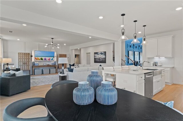 interior space featuring light hardwood / wood-style floors, a chandelier, and sink