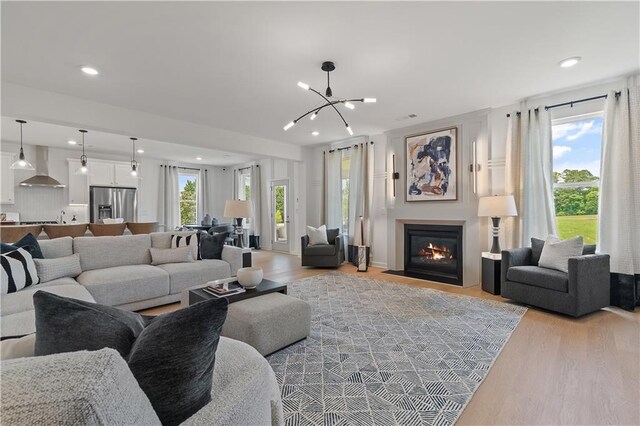 living room featuring a notable chandelier and light hardwood / wood-style floors