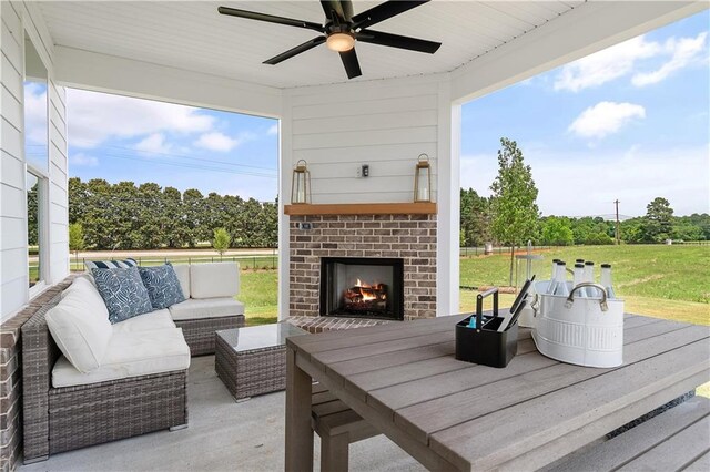 view of patio featuring an outdoor living space with a fireplace and ceiling fan