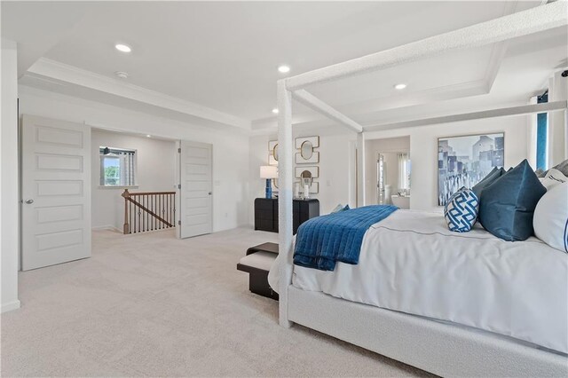 bedroom featuring a tray ceiling, light colored carpet, and crown molding