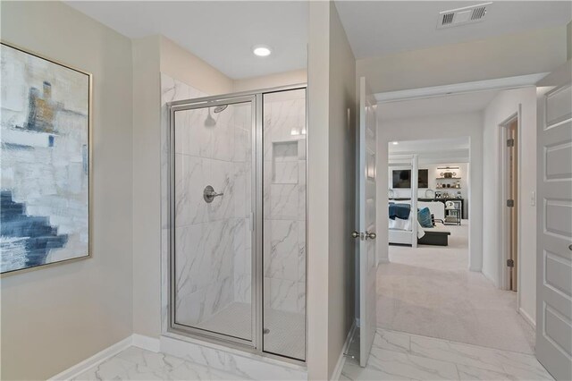 bathroom featuring a shower with shower door