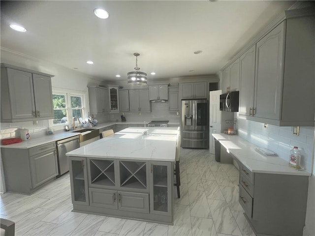 kitchen with glass insert cabinets, gray cabinets, marble finish floor, and stainless steel appliances