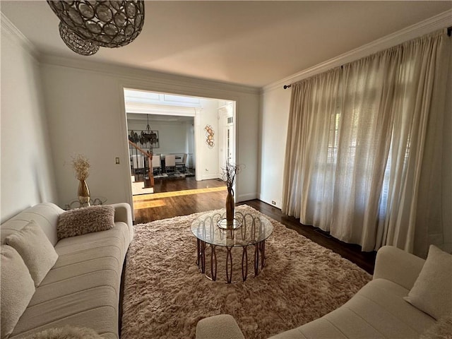 living room with crown molding and wood finished floors