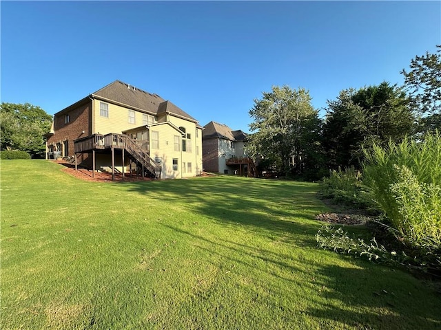 view of yard featuring stairway and a wooden deck