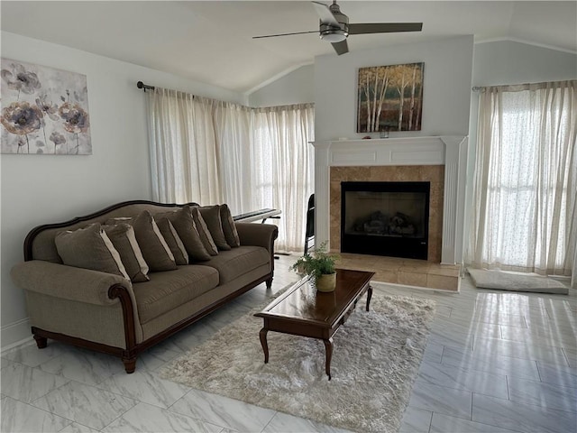 living area featuring a tiled fireplace, lofted ceiling, marble finish floor, and ceiling fan