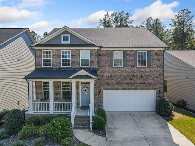 view of front of home with a garage and a porch