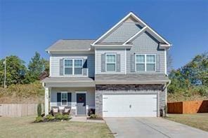 view of front of home with a front yard and a garage