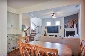 dining area featuring ceiling fan and dark hardwood / wood-style floors