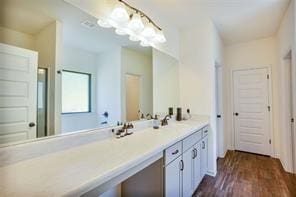 bathroom with hardwood / wood-style floors and vanity