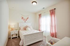 bedroom featuring dark carpet