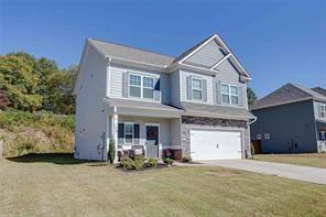 view of front of home with a front lawn and a garage