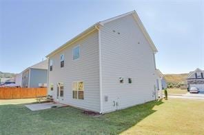 back of property featuring a patio area and a yard