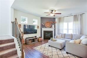 living room with ceiling fan and light wood-type flooring