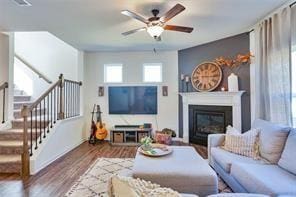 living room with ceiling fan and hardwood / wood-style floors