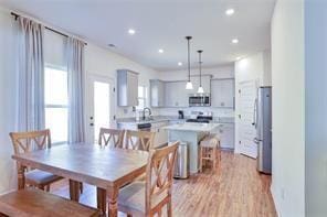 dining area featuring light wood-type flooring