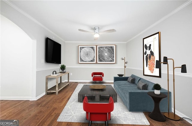 living room featuring hardwood / wood-style flooring, crown molding, and ceiling fan