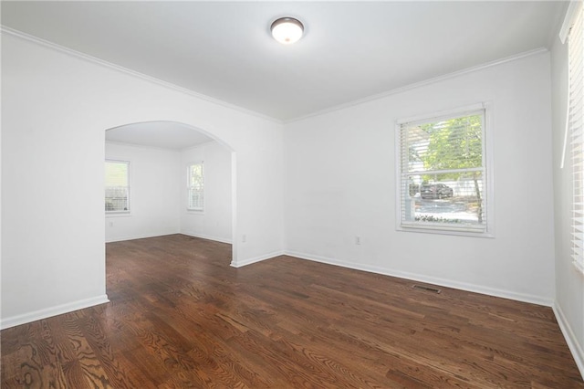 empty room featuring dark hardwood / wood-style flooring and ornamental molding