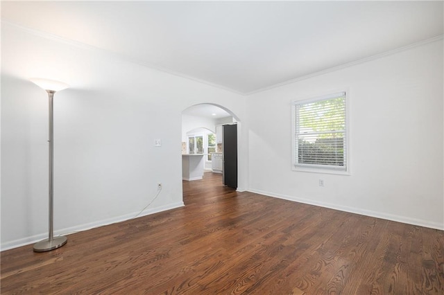 spare room with crown molding and dark hardwood / wood-style floors