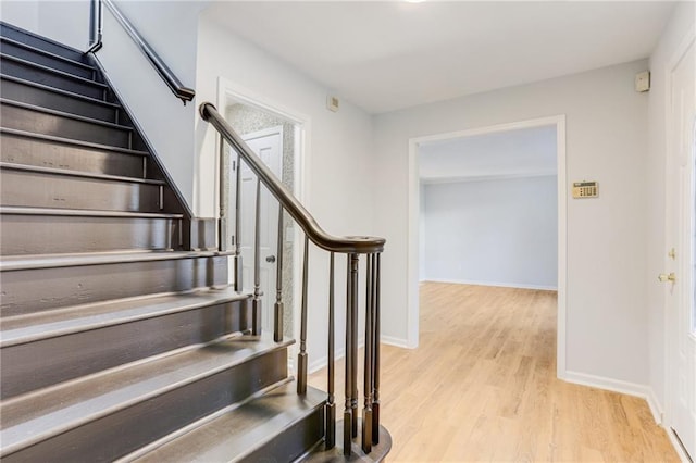 stairs featuring wood-type flooring