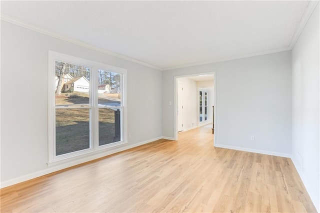 spare room featuring ornamental molding and light wood-type flooring