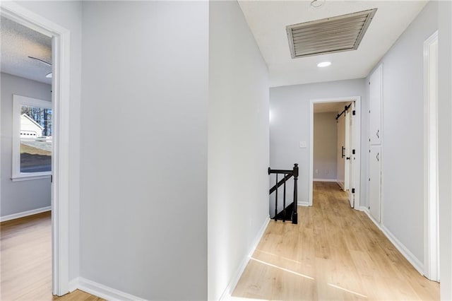 hallway with light wood-type flooring